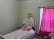 Bright bedroom with natural light and a cozy bed with pink plushies and accents at 504 Delido Way, Kissimmee, FL 34758