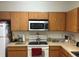 Bright kitchen with wooden cabinets, microwave, and ample countertop space at 504 Delido Way, Kissimmee, FL 34758