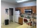 Functional kitchen featuring a white refrigerator, microwave and wooden cabinetry at 504 Delido Way, Kissimmee, FL 34758