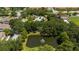 Aerial view of a community featuring a pond with a fountain and mature trees surrounding at 5356 Diplomat Ct # 105, Kissimmee, FL 34746