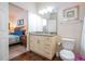 Bright bathroom featuring a granite vanity top, white cabinets, and modern lighting fixture at 5356 Diplomat Ct # 105, Kissimmee, FL 34746