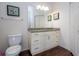 Bathroom featuring a white vanity with a granite countertop and modern fixtures at 5356 Diplomat Ct # 105, Kissimmee, FL 34746