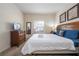 Well-lit bedroom with a wooden dresser, mirror, and a plush bed, perfect for a peaceful night's sleep at 5356 Diplomat Ct # 105, Kissimmee, FL 34746