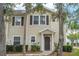 Charming two-story townhome with neutral siding, brown shutters and door, and well-maintained landscaping at 5356 Diplomat Ct # 105, Kissimmee, FL 34746