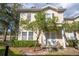 Two-story townhouse with tan siding, dark brown shutters, and a well-manicured lawn at 5356 Diplomat Ct # 105, Kissimmee, FL 34746