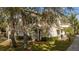 Exterior view of townhome featuring manicured front garden and driveway at 5356 Diplomat Ct # 105, Kissimmee, FL 34746