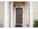 Close-up of a brown front door with white trim and pillars, featuring a modern lock and the unit number at 5356 Diplomat Ct # 105, Kissimmee, FL 34746