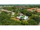 Aerial view of a community pool area with palm trees and lush landscaping at Lucaya Village at 5356 Diplomat Ct # 105, Kissimmee, FL 34746