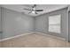 A bright bedroom featuring neutral paint, ceiling fan, and tiled floors at 5424 Pinto Way, Orlando, FL 32810