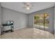 Neutral bedroom with sliding glass doors to the backyard and light tile flooring at 5424 Pinto Way, Orlando, FL 32810