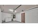 Garage interior with a washer, dryer, water heater, and door to the house at 5424 Pinto Way, Orlando, FL 32810