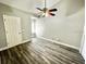 Neutral bedroom with wood-look floors, ceiling fan, and white trim offers lots of natural light at 615 Richland Ct # 66, Altamonte Springs, FL 32714