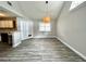 Open-concept dining room features gray walls, wood-look flooring, and access to the kitchen and covered patio at 615 Richland Ct # 66, Altamonte Springs, FL 32714