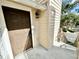 This neutral-colored entrance features a brown front door, a door bell, and an outdoor light fixture at 615 Richland Ct # 66, Altamonte Springs, FL 32714