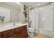 Well-lit bathroom with a shower-tub combo and stylish floral accents at 620 Orange Cosmos Blvd, Davenport, FL 33837