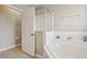 Bathroom view showcasing corner tub, shower with glass, and tile flooring at 620 Orange Cosmos Blvd, Davenport, FL 33837