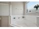 White-tiled corner bathtub with a window; a bright and calming bathroom feature at 620 Orange Cosmos Blvd, Davenport, FL 33837