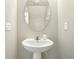 Powder room with a pedestal sink, oval mirror and white walls at 620 Orange Cosmos Blvd, Davenport, FL 33837