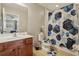 Bathroom with matching geometric shower curtain, toilet cover, and floor mat at 620 Orange Cosmos Blvd, Davenport, FL 33837