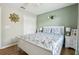 Bedroom with white trim, a floral comforter, and an accent wall at 620 Orange Cosmos Blvd, Davenport, FL 33837