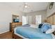 Bedroom with hardwood floors, natural light, neutral colors, and a view to the en suite bath at 620 Orange Cosmos Blvd, Davenport, FL 33837