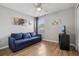 Cozy bedroom featuring a comfortable blue sofa bed and ceiling fan at 620 Orange Cosmos Blvd, Davenport, FL 33837