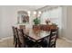 Dining area with long wooden table and chairs with modern pendant lighting at 620 Orange Cosmos Blvd, Davenport, FL 33837