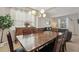 Dining room features a large wooden table, buffet, and a view to the living room at 620 Orange Cosmos Blvd, Davenport, FL 33837