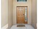 Inviting front entrance featuring a solid wood door with sidelight and welcome mat at 620 Orange Cosmos Blvd, Davenport, FL 33837