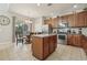 Kitchen with stainless steel appliances, granite countertops, island with bar stool seating, and a view to the lanai at 620 Orange Cosmos Blvd, Davenport, FL 33837