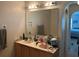 Bathroom featuring double sinks, large mirror, and modern lighting at 6743 Sw 129Th St, Ocala, FL 34473