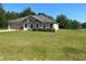 Single-story home showcases a well-maintained lawn, attached garage, and a charming front facade at 6743 Sw 129Th St, Ocala, FL 34473