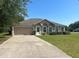 Charming single-story home boasts a well-manicured lawn, attached garage, and a welcoming front entrance at 6743 Sw 129Th St, Ocala, FL 34473