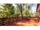 View from the painted wood deck to the backyard trees at 690 Shady Ct, Altamonte Springs, FL 32701