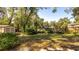 Fenced in backyard features green grass, small shed and beautiful greenery at 690 Shady Ct, Altamonte Springs, FL 32701