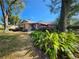 View of home's backyard with lush landscaping, mature trees and peaceful setting at 690 Shady Ct, Altamonte Springs, FL 32701