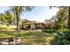 Expansive backyard featuring mature trees, a firepit, and a screened in patio at 690 Shady Ct, Altamonte Springs, FL 32701