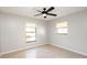 A bright bedroom with tile flooring and ample natural light from the two large windows at 690 Shady Ct, Altamonte Springs, FL 32701