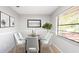 Elegant dining room featuring a glass table, seating for six, and a view of the outdoor at 690 Shady Ct, Altamonte Springs, FL 32701