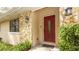 Up-close view of the front door enhanced by a decorative window, stone siding, and green plants at 690 Shady Ct, Altamonte Springs, FL 32701