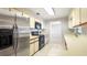 Functional kitchen with stainless steel refrigerator, white cabinets and neutral countertops at 690 Shady Ct, Altamonte Springs, FL 32701