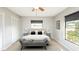 Well-lit main bedroom with neutral colors, a comfy bed, tile floor, and closet space at 690 Shady Ct, Altamonte Springs, FL 32701