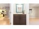 Hallway view of a powder room with modern vanity, looking into the kitchen and a bedroom at 690 Shady Ct, Altamonte Springs, FL 32701