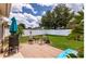 Backyard patio featuring outdoor seating, green grass, tropical plants, and a white vinyl fence at 730 Garberia Dr, Davenport, FL 33837