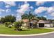 Beautiful single-story home with lush green lawn, tropical landscaping, and a two-car garage at 730 Garberia Dr, Davenport, FL 33837