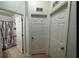 Hallway with a view of a bathroom with a tub/shower combo and storage closets at 730 Garberia Dr, Davenport, FL 33837