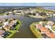 Aerial view of a waterfront community with manicured lawns and backyard docks on a beautiful lake at 890 Spinnaker Way, Kissimmee, FL 34746