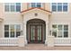 Close up of front entrance featuring a decorative dark door and a brick paver walkway at 890 Spinnaker Way, Kissimmee, FL 34746