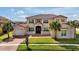 Stunning two-story home with a terracotta tile roof, lush lawn, and charming front porch at 890 Spinnaker Way, Kissimmee, FL 34746