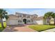 A two story house with a terracotta roof, two-car garage, and lovely front yard at 890 Spinnaker Way, Kissimmee, FL 34746